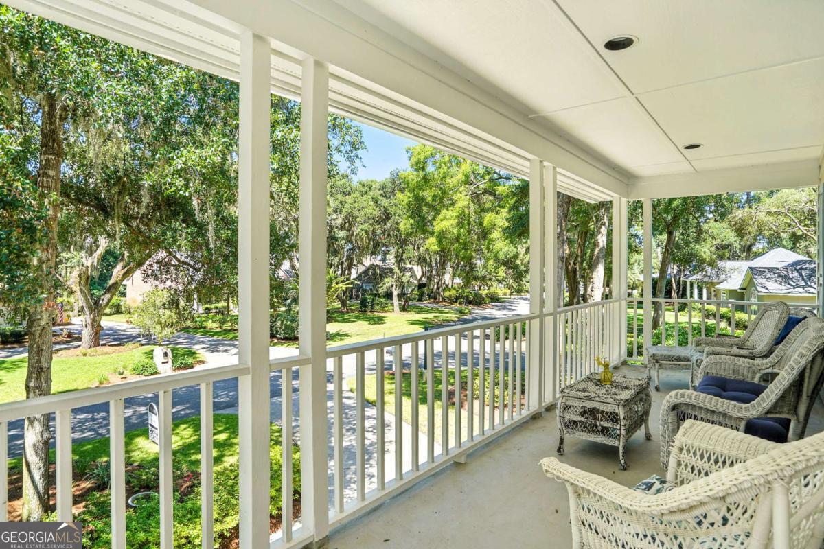 202 Vassar Point Drive St. Simons, GA 31522 - Photo 30 of 62 a view of a chair and tables in the balcony
