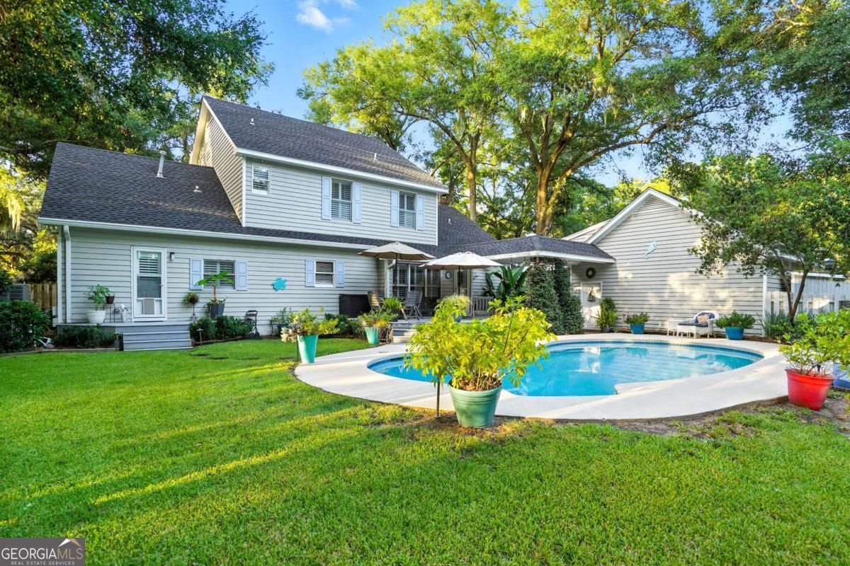 202 Vassar Point Drive St. Simons, GA 31522 - Photo 3 of 62 a view of house with a yard porch and sitting area