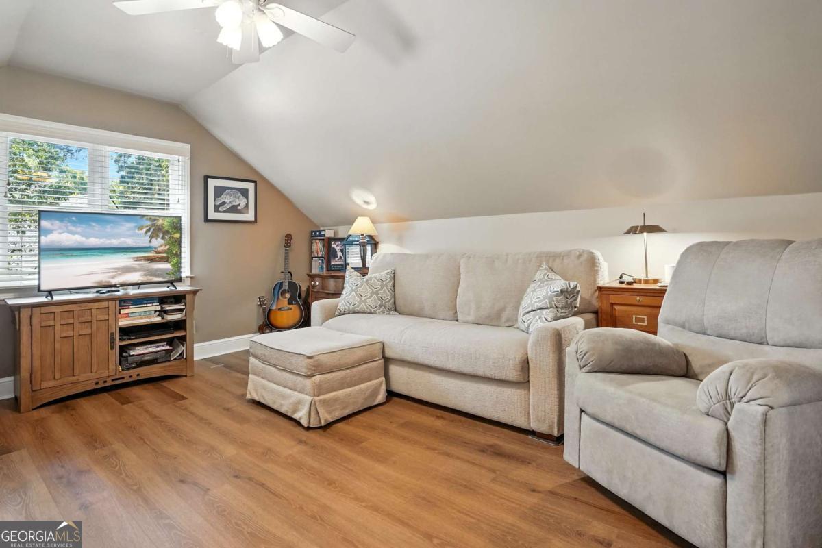 202 Vassar Point Drive St. Simons, GA 31522 - Photo 31 of 62 a living room with furniture and a flat screen tv