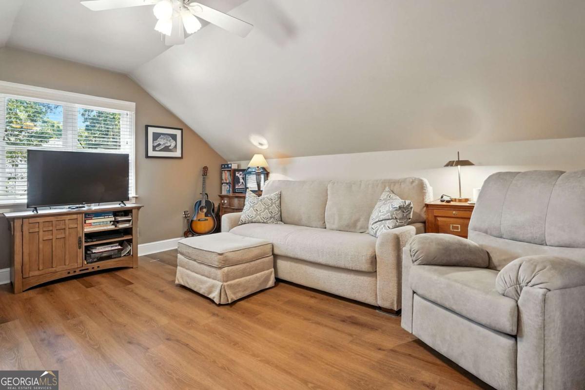 202 Vassar Point Drive St. Simons, GA 31522 - Photo 32 of 62 a living room with furniture and a flat screen tv
