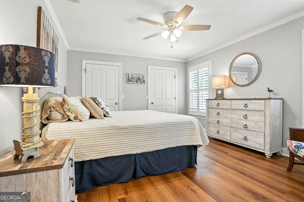 202 Vassar Point Drive St. Simons, GA 31522 - Photo 34 of 62 a bedroom with a bed and wooden floor