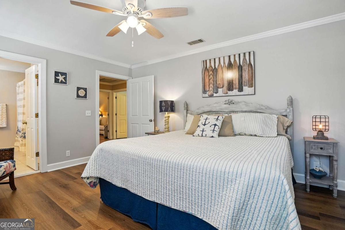 202 Vassar Point Drive St. Simons, GA 31522 - Photo 35 of 62 a bedroom with a bed and a chandelier