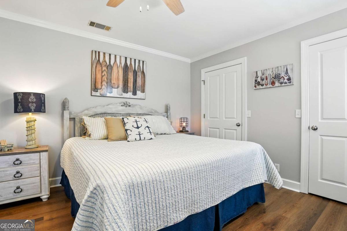 202 Vassar Point Drive St. Simons, GA 31522 - Photo 37 of 62 a bedroom with a bed and a night stand