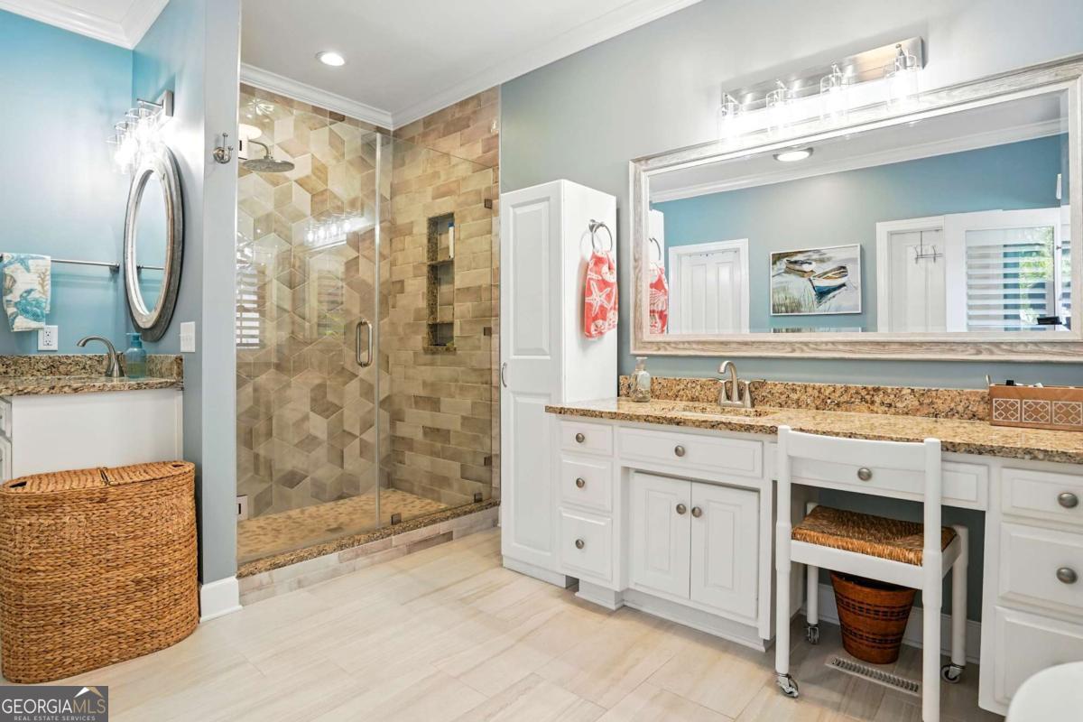 202 Vassar Point Drive St. Simons, GA 31522 - Photo 44 of 62 a spacious bathroom with a granite countertop sink mirror and shower