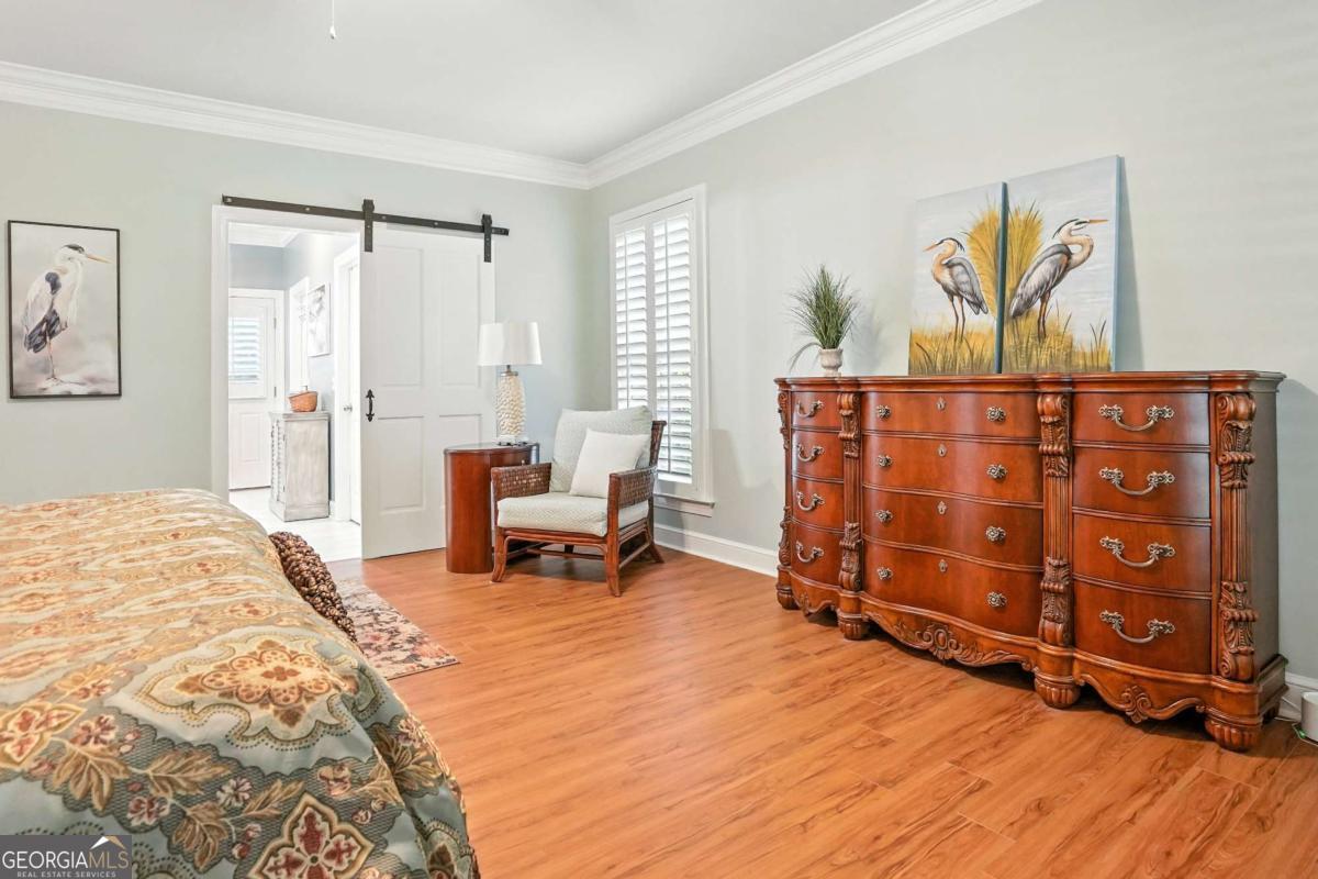 202 Vassar Point Drive St. Simons, GA 31522 - Photo 45 of 62 a bedroom with furniture and a wooden floor