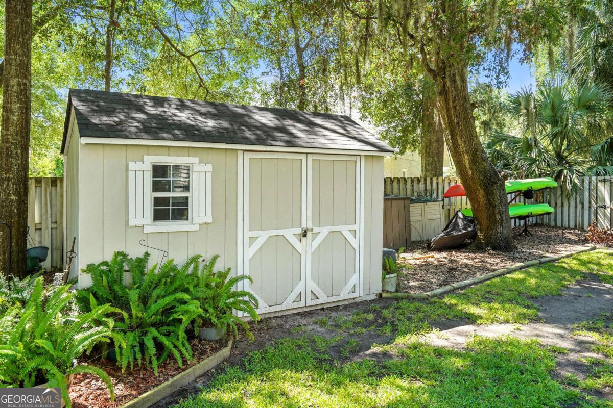 202 Vassar Point Drive St. Simons, GA 31522 - Photo 50 of 62 a view of a house with backyard and a tree