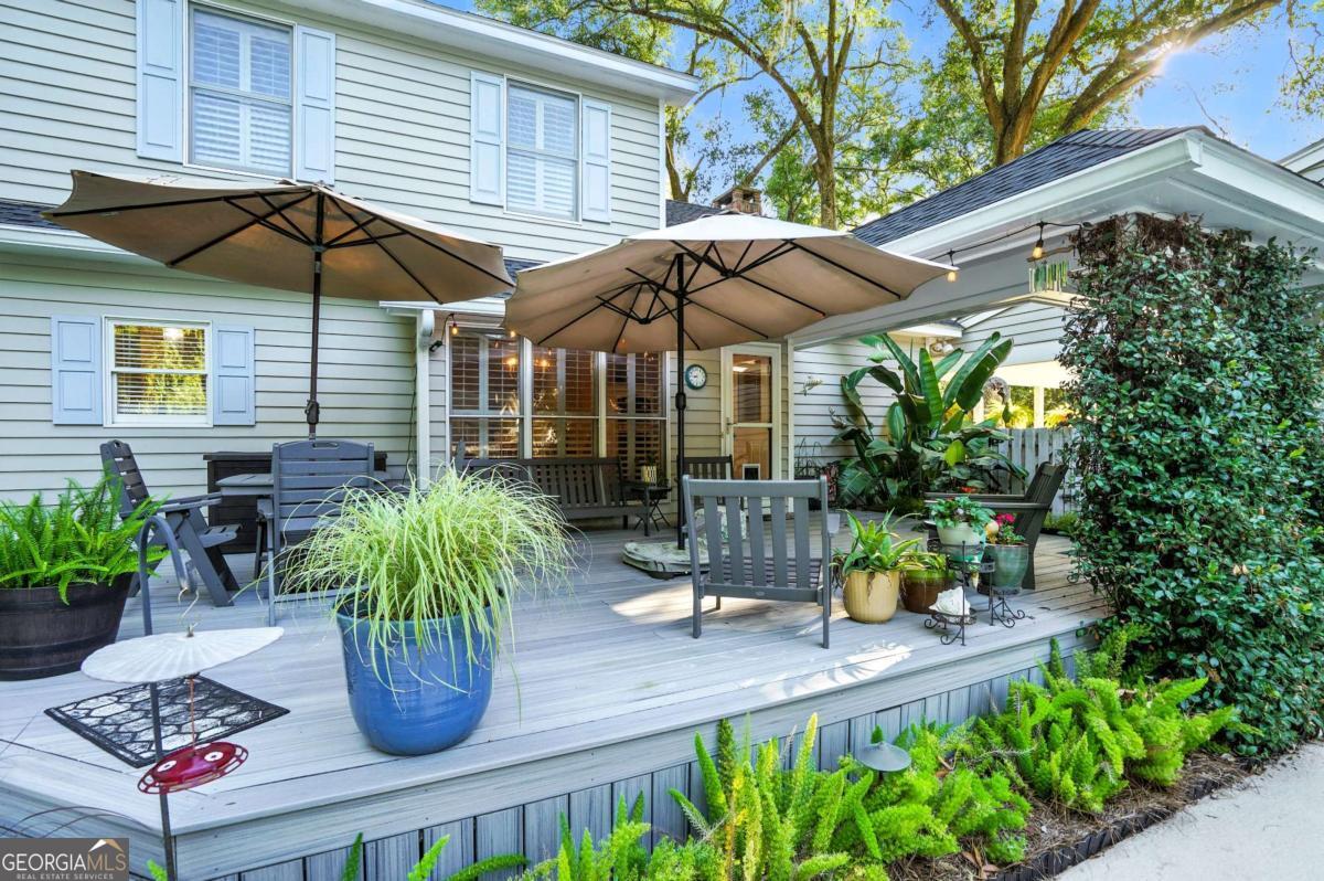 202 Vassar Point Drive St. Simons, GA 31522 - Photo 52 of 62 a view of a chair and table under an umbrella