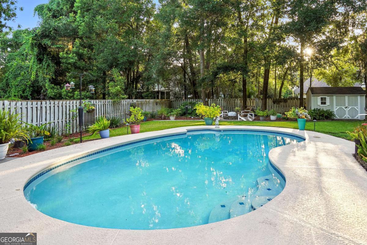 202 Vassar Point Drive St. Simons, GA 31522 - Photo 59 of 62 a view of a swimming pool with an outdoor seating