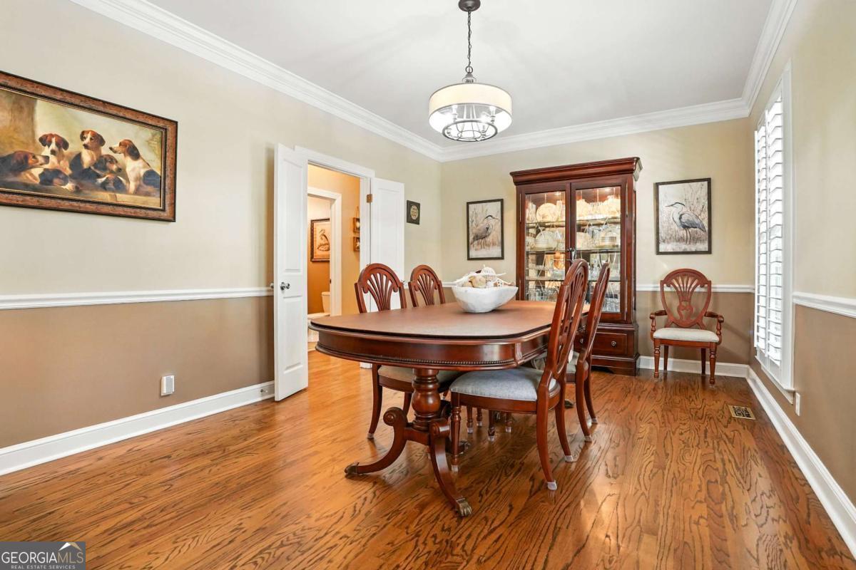 202 Vassar Point Drive St. Simons, GA 31522 - Photo 6 of 62 a view of a dining room with furniture a chandelier and wooden floor