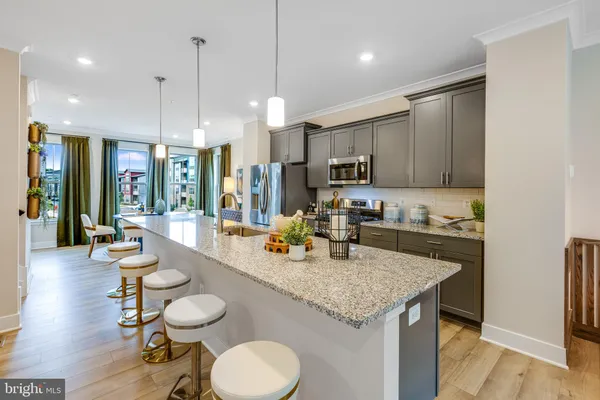 a kitchen with a stove a refrigerator and a sink