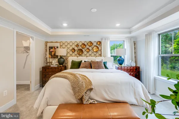 a bed sitting in a bedroom next to a window