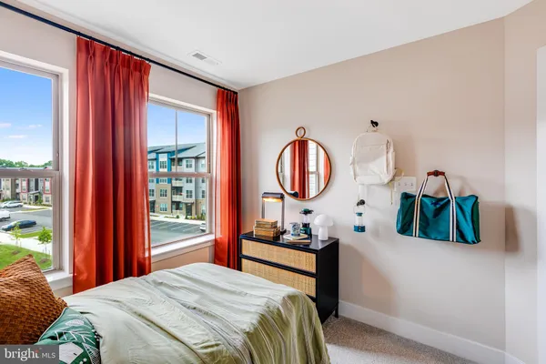 a bedroom with bed and a window
