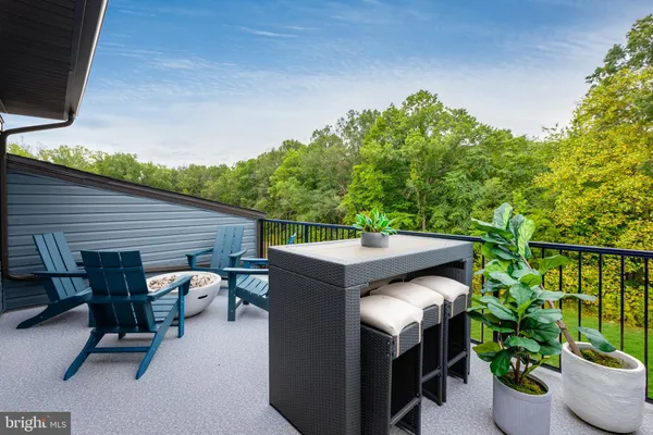 a backyard of a house with table and chairs potted plants