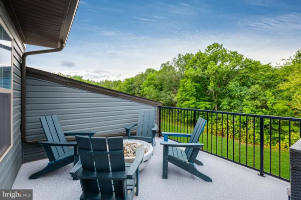 a view of a chairs and table in the roof deck