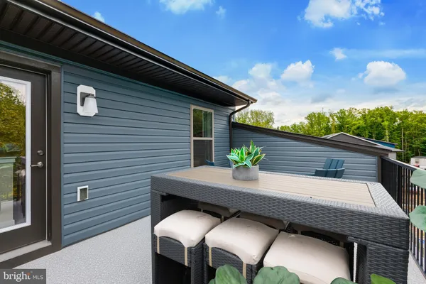 a backyard of a house with wooden floor yard outdoor seating and yard in back
