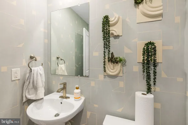 a bathroom with a sink a toilet and a mirror