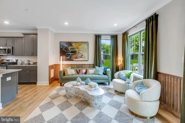 a living room with furniture and large windows