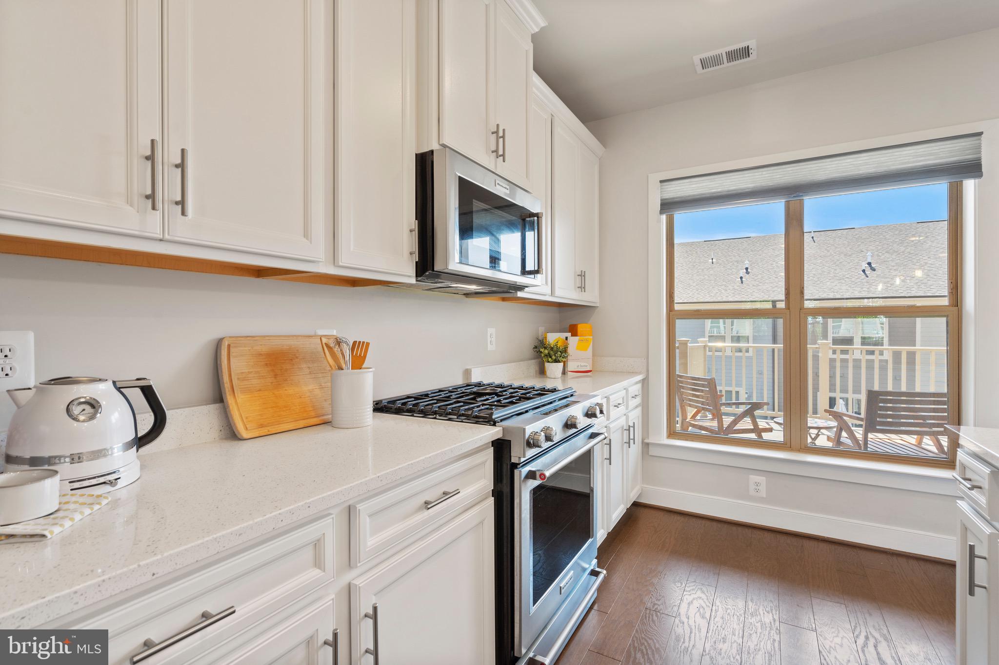 9580 Fields Road Gaithersburg, MD 20878 - Photo 12 of 58 a kitchen with stainless steel appliances granite countertop a stove and a sink