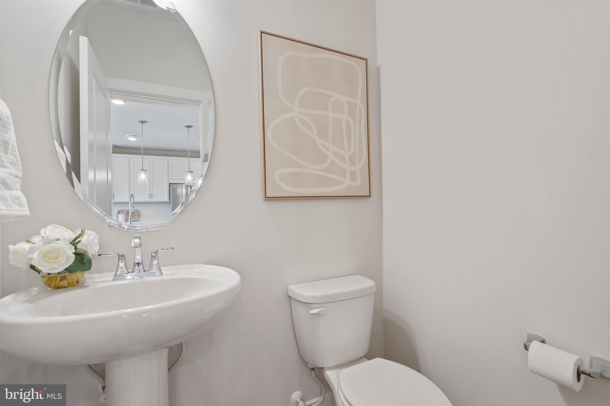 9580 Fields Road Gaithersburg, MD 20878 - Photo 16 of 58 a bathroom with a toilet a sink and mirror