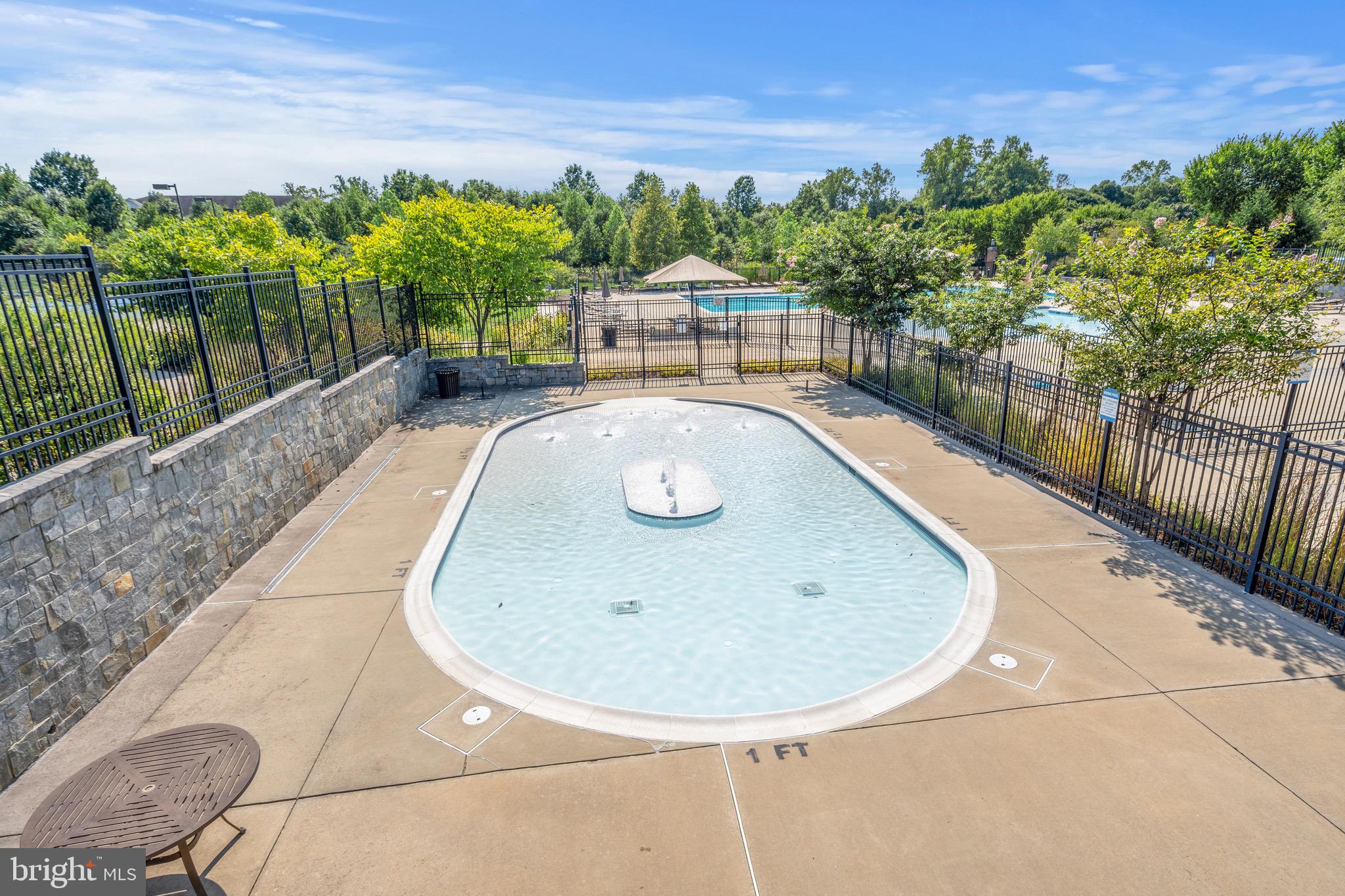 9580 Fields Road Gaithersburg, MD 20878 - Photo 44 of 58 a view of a swimming pool with a patio