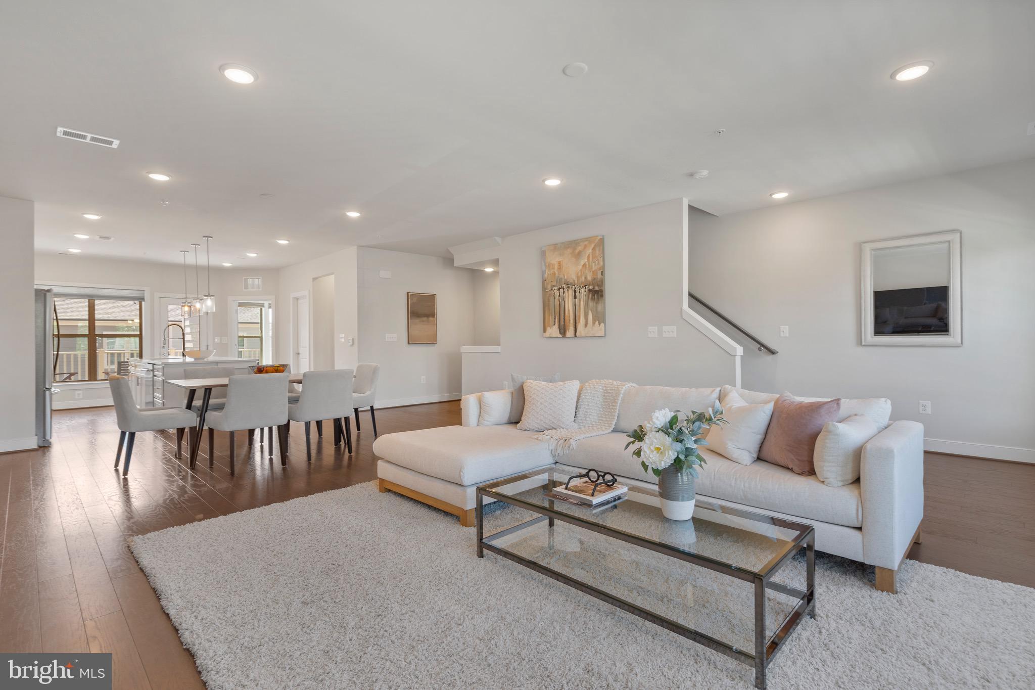 9580 Fields Road Gaithersburg, MD 20878 - Photo 7 of 58 a living room with furniture and a dining table with wooden floor