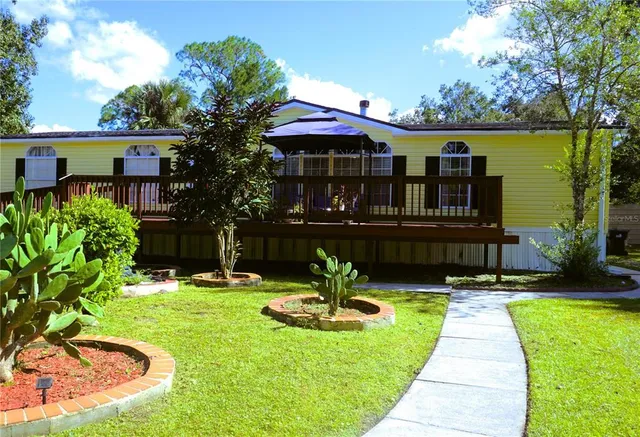 a view of a chair and tables in the patio and a fountain
