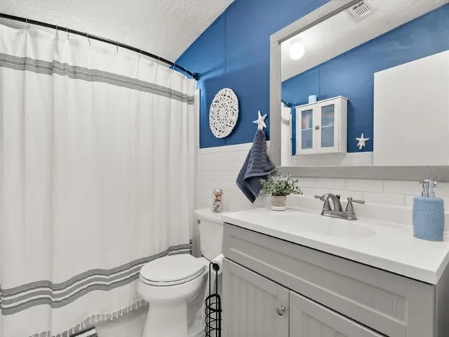 a bathroom with a toilet a sink and a mirror