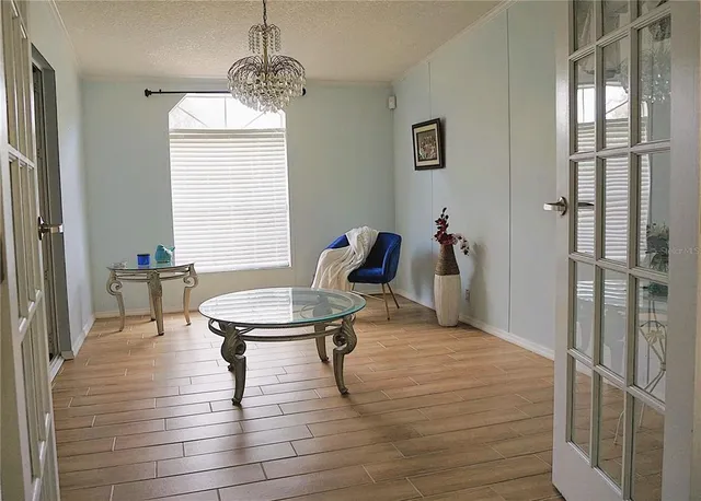 a living room with furniture a window and a chandelier