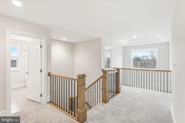 a view of a hallway with windows and stairs