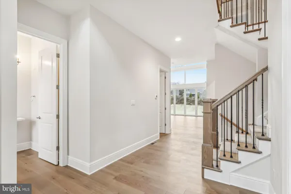 a view of a hallway with wooden floor and entryway