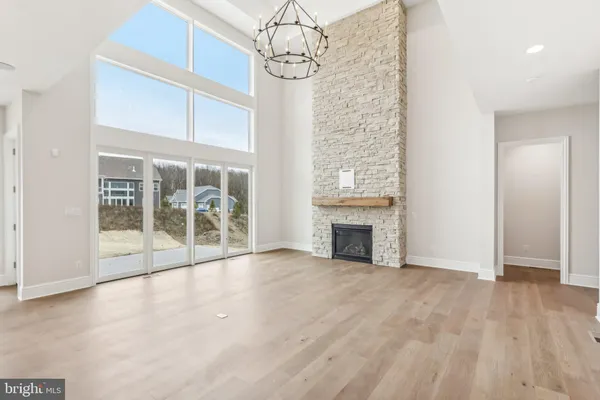 a view of empty room with wooden floor and fireplace