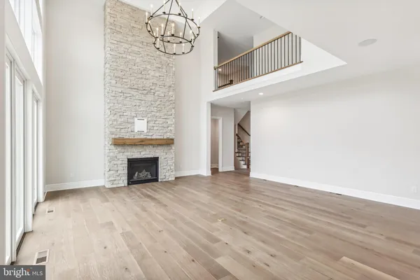 an entryway with a fireplace and wooden floor