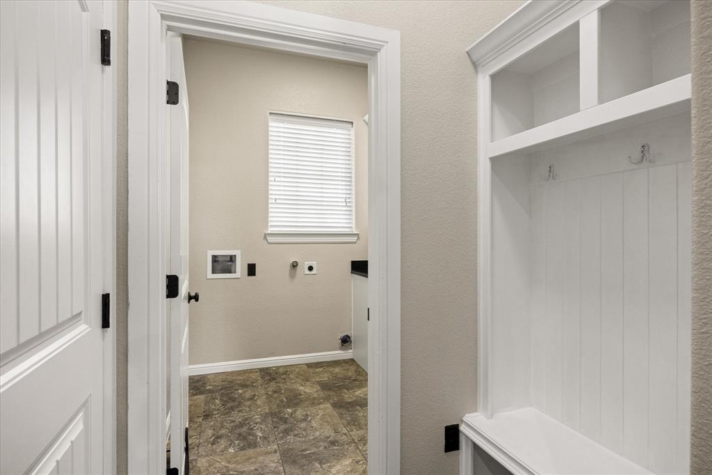3711 Lonesome Creek Road Granbury, TX 76049 - Photo 12 of 39 Keep things tidy with this footlocker storage just off the garage entrance and laundry room.