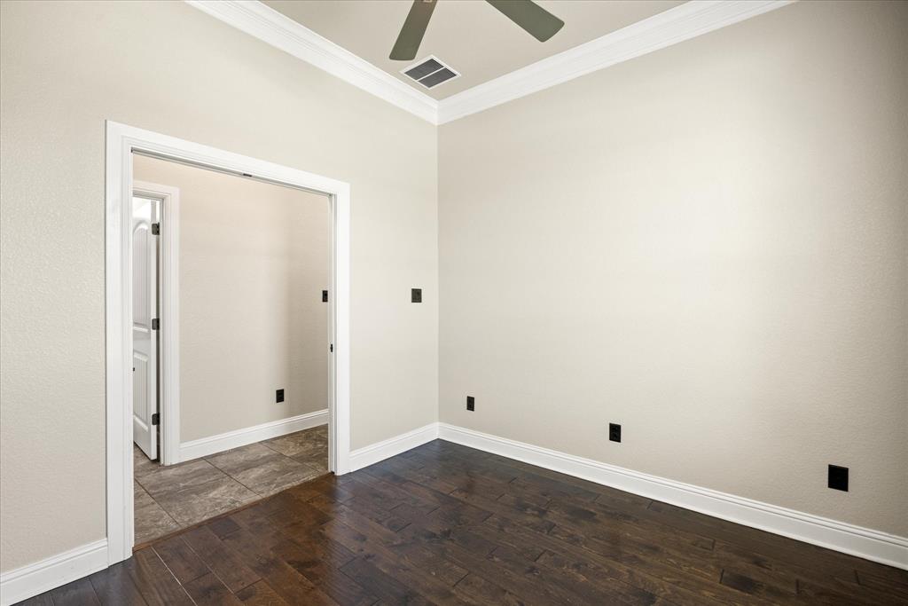 3711 Lonesome Creek Road Granbury, TX 76049 - Photo 19 of 39 Home office with wood floors, ceiling fan and pocket doors for privacy. Half bath located just across the hall.
