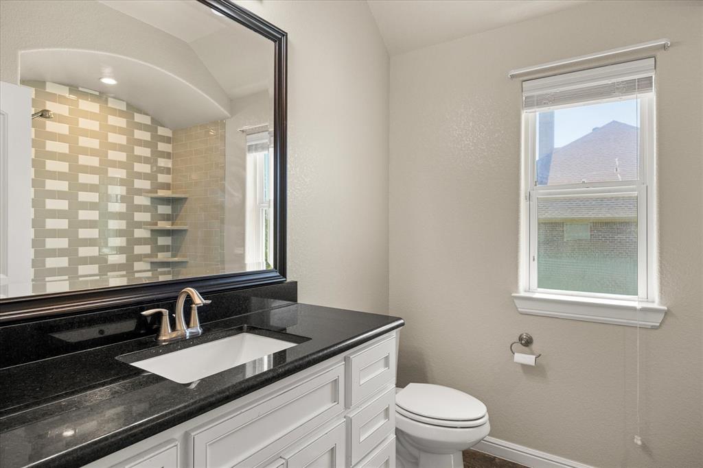 3711 Lonesome Creek Road Granbury, TX 76049 - Photo 25 of 39 Secondary full bath with designer tilework in the tub and shower.