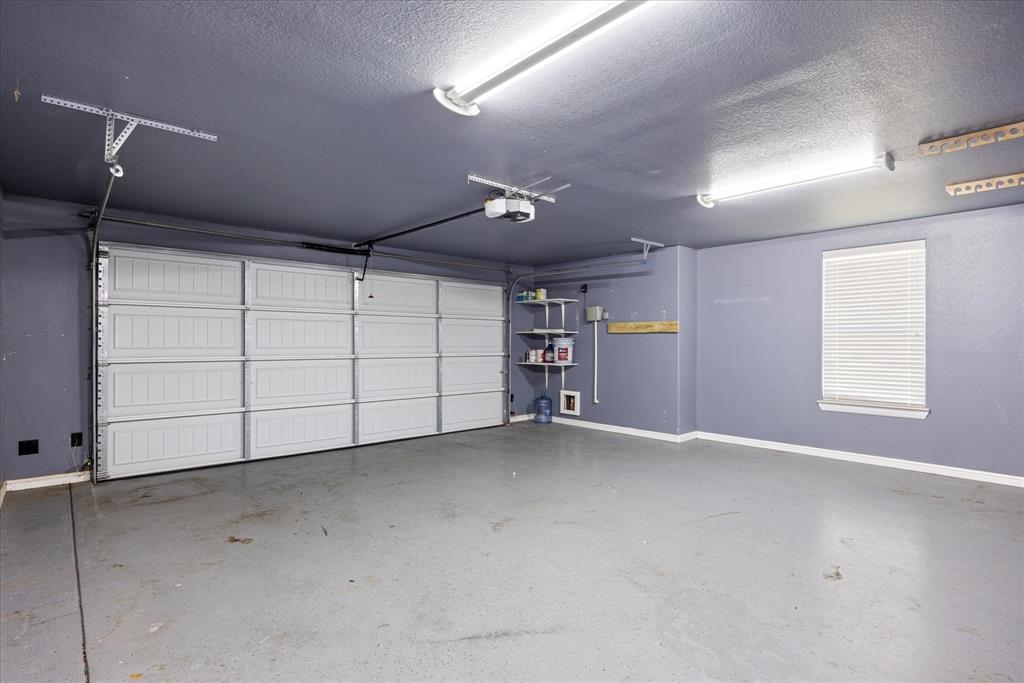 3711 Lonesome Creek Road Granbury, TX 76049 - Photo 37 of 39 Wide garage with room for extra fridge or tools. Epoxied floor. Irrigation system.