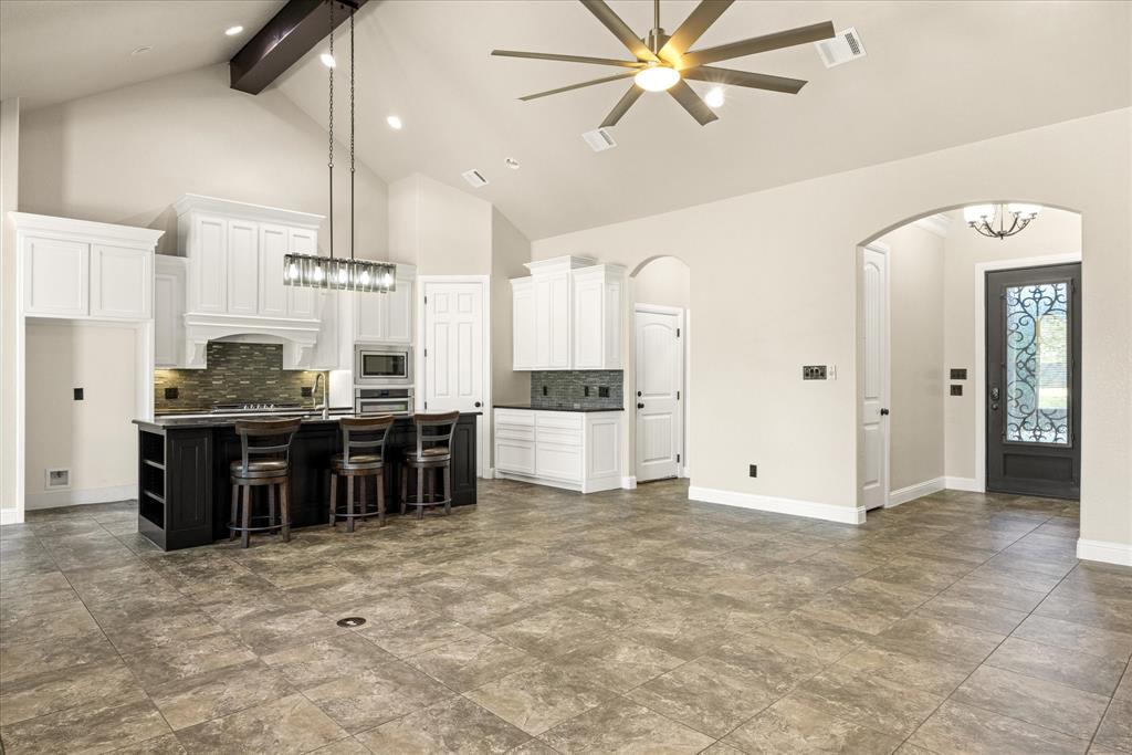 3711 Lonesome Creek Road Granbury, TX 76049 - Photo 4 of 39 Upon entry you are welcomed into a grand open concept space with vaulted ceiling and a wall of windows offering great natural light.