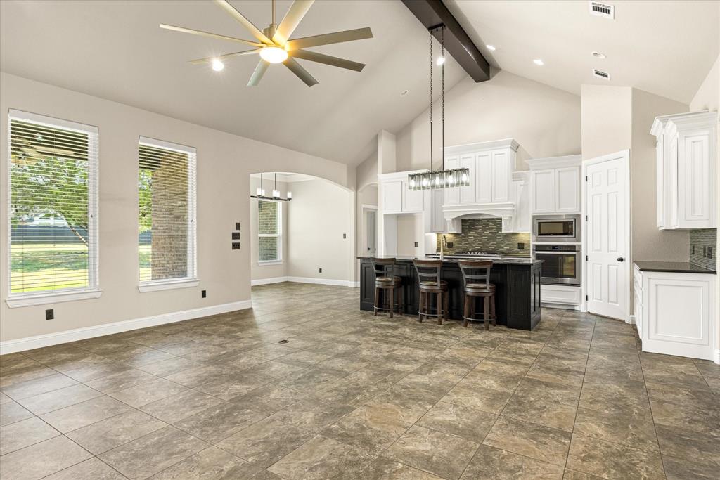 3711 Lonesome Creek Road Granbury, TX 76049 - Photo 5 of 39 Sun drenched living room and views to the back yard. Back of home faces NE so no hot sun in the afternoon.