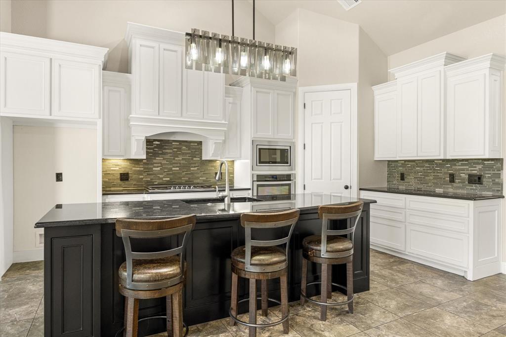 3711 Lonesome Creek Road Granbury, TX 76049 - Photo 6 of 39 Spacious kitchen island with granite counters and bar seating.