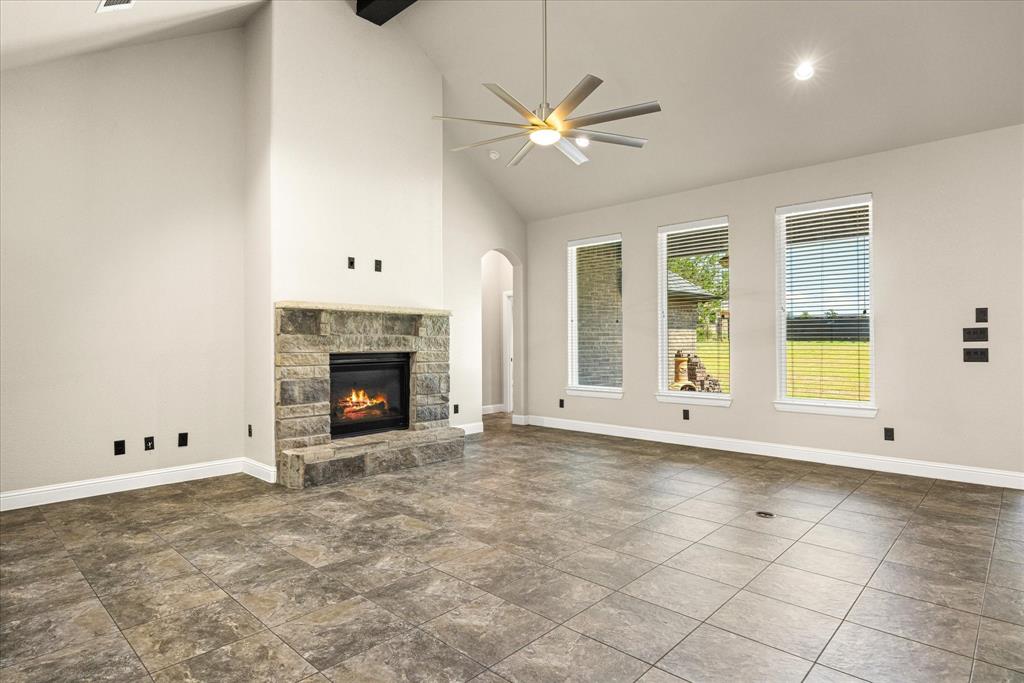 3711 Lonesome Creek Road Granbury, TX 76049 - Photo 8 of 39 Gas fireplace offers a quick and easy way to make the living room a cozy heart of the home.