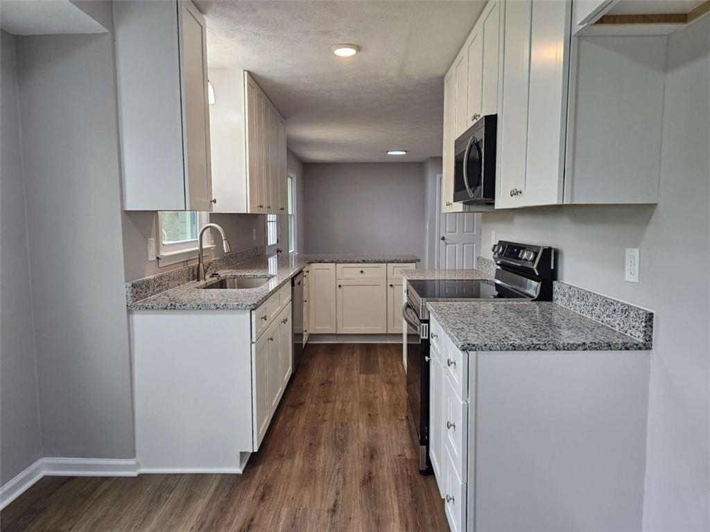 6470 Michell Way Douglasville, GA 30135 - Photo 13 of 41 a kitchen with a sink stove top oven and cabinets