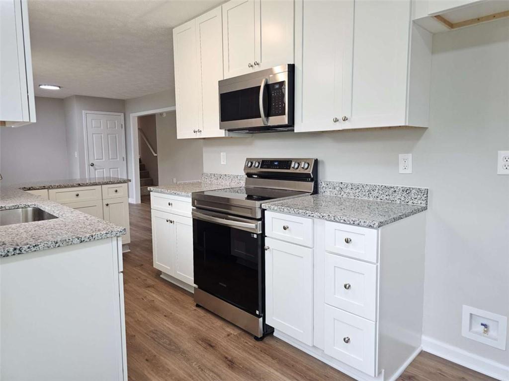 6470 Michell Way Douglasville, GA 30135 - Photo 15 of 41 a kitchen with granite countertop white cabinets and stainless steel appliances