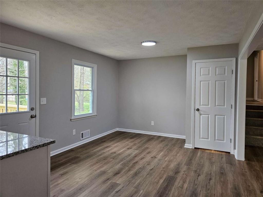 6470 Michell Way Douglasville, GA 30135 - Photo 19 of 41 an empty room with wooden floor and windows