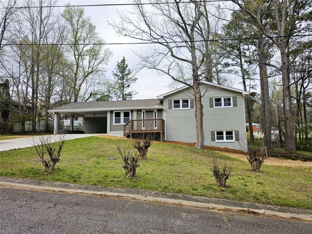 6470 Michell Way Douglasville, GA 30135 - Photo 2 of 41 a front view of a house with a yard and trees