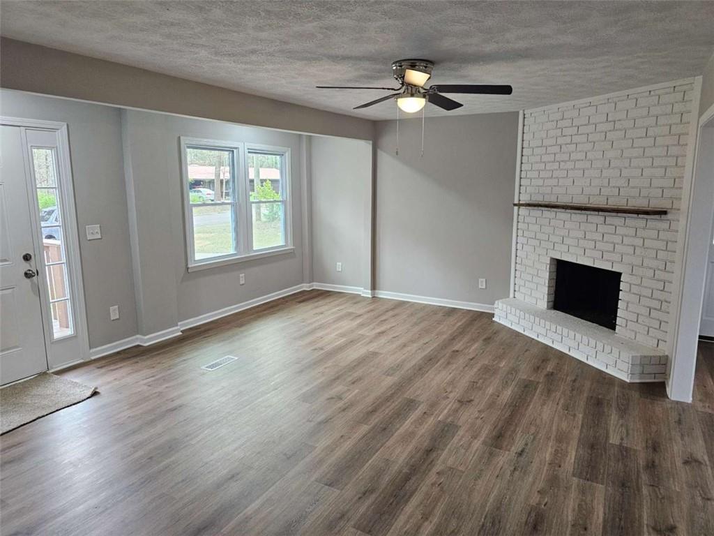 6470 Michell Way Douglasville, GA 30135 - Photo 30 of 41 an empty room with wooden floor fireplace and windows