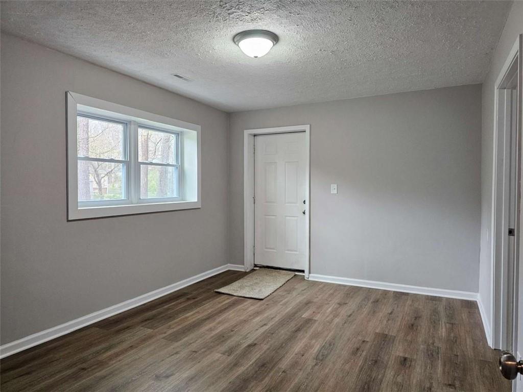6470 Michell Way Douglasville, GA 30135 - Photo 32 of 41 an empty room with wooden floor and windows