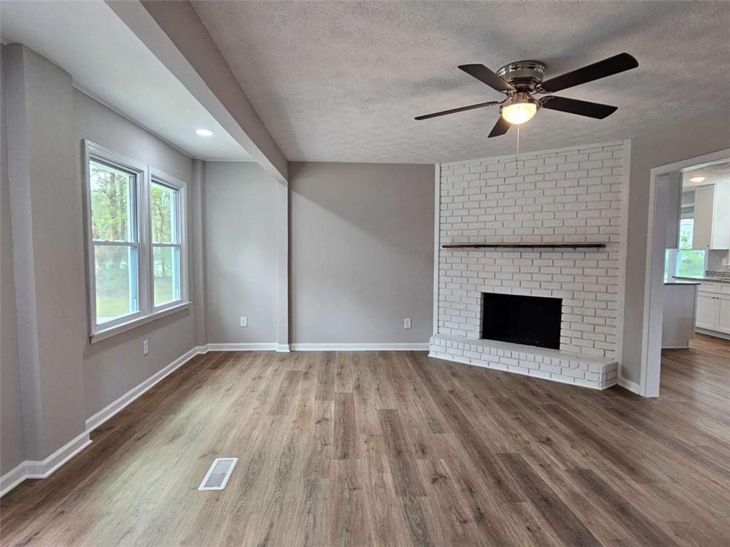 6470 Michell Way Douglasville, GA 30135 - Photo 5 of 41 a view of empty room with wooden floor and fireplace