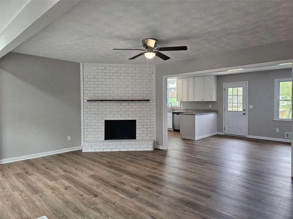 6470 Michell Way Douglasville, GA 30135 - Photo 6 of 41 a view of a livingroom with a fireplace a ceiling fan and windows