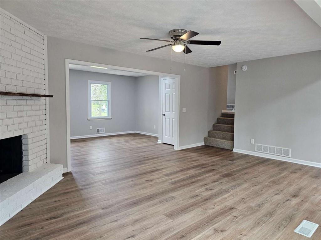 6470 Michell Way Douglasville, GA 30135 - Photo 7 of 41 a view of an empty room with wooden floor fireplace and a window