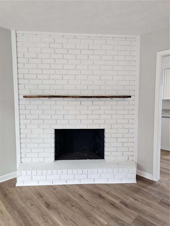 6470 Michell Way Douglasville, GA 30135 - Photo 9 of 41 a view of an empty room with wooden floor and a fireplace